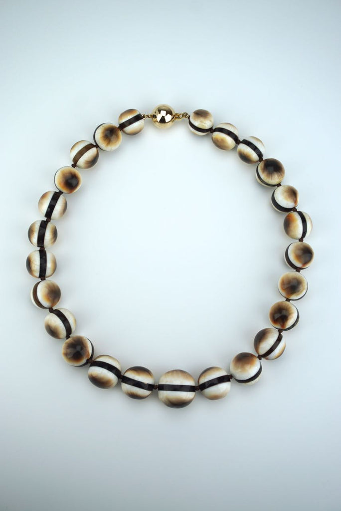 Operculum and tortoiseshell beads
