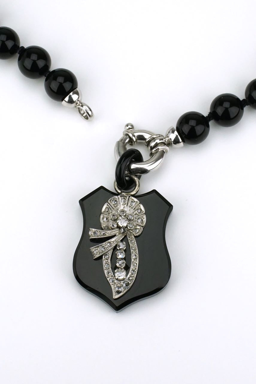 Diamond and onyx shield necklace