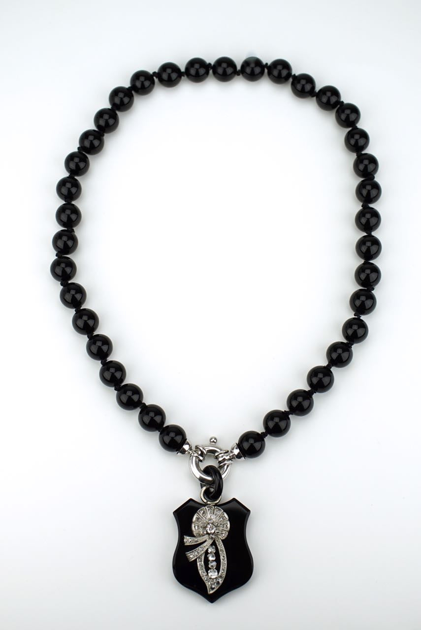 Diamond and onyx shield necklace