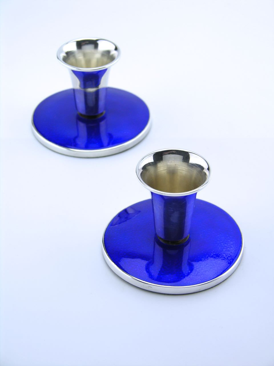 Meka pair of silver and deep blue enamel candleholders