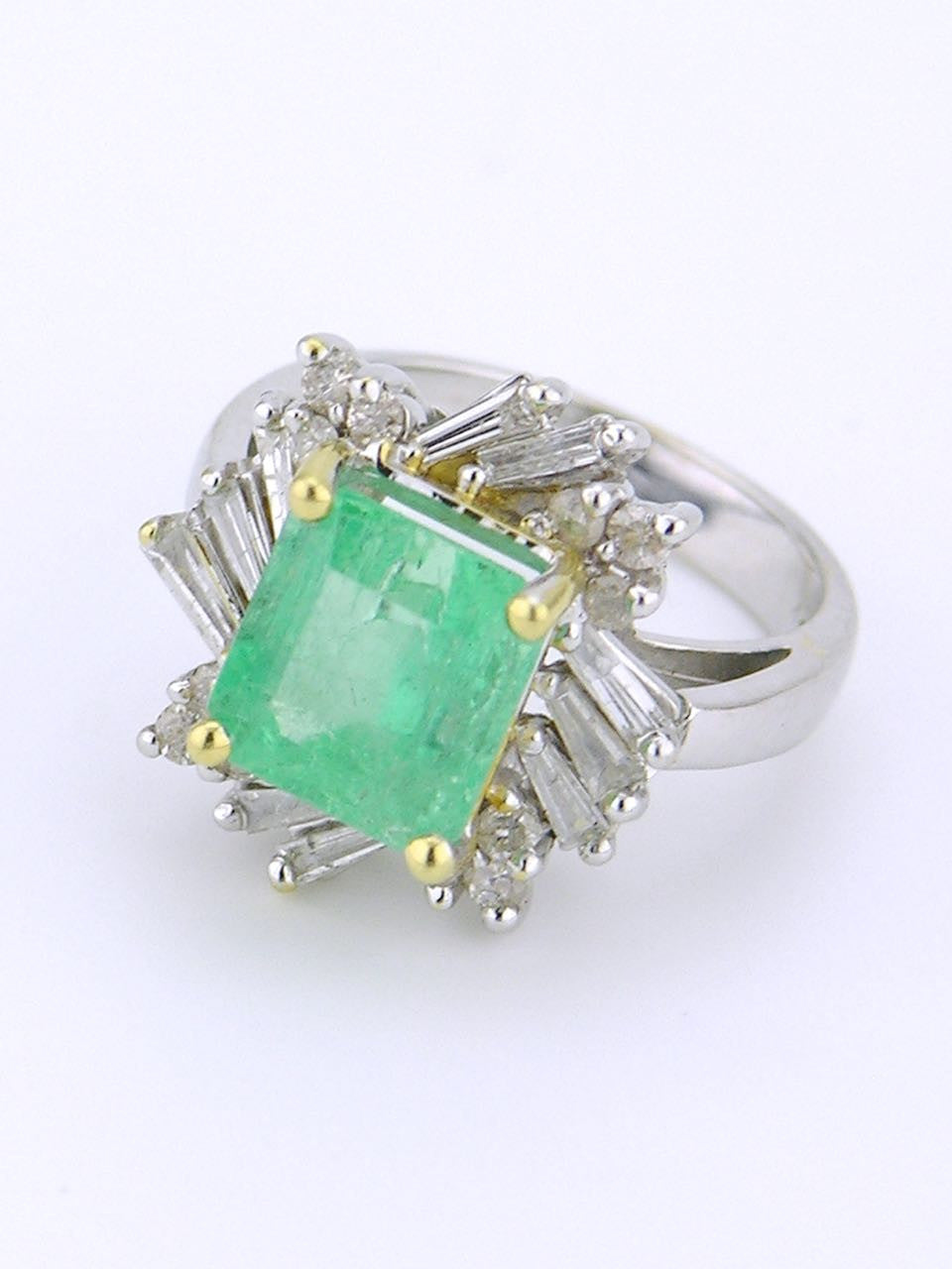 White gold emerald and diamond cluster ring