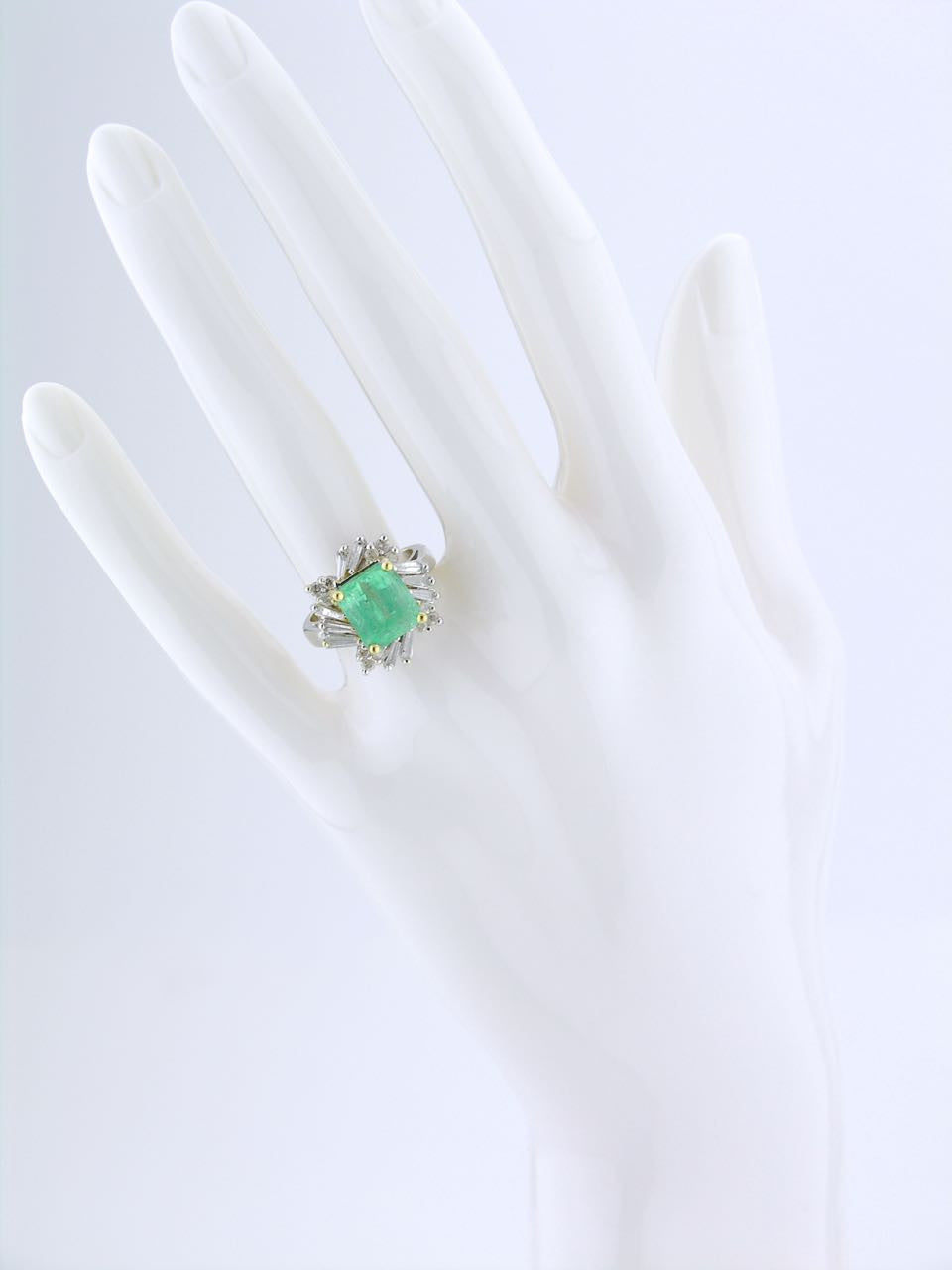 White gold emerald and diamond cluster ring